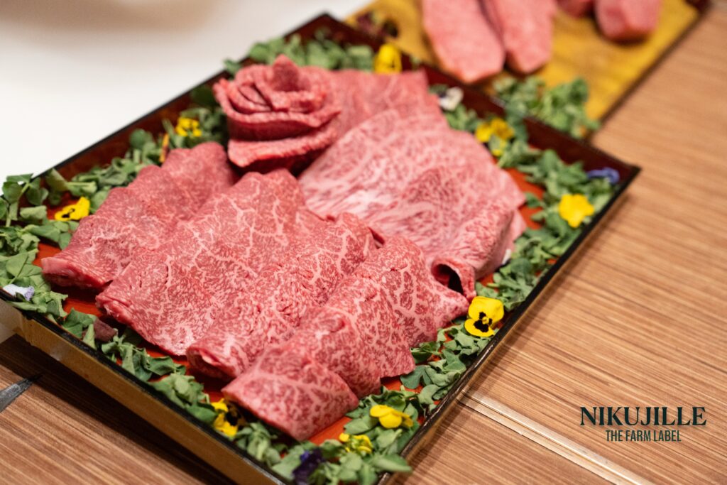 Sliced A5 wagyu beef with rose garnish on a wooden platter
