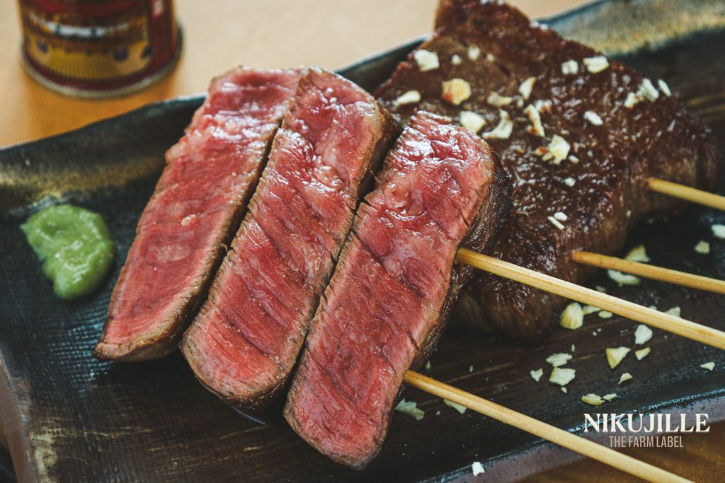 Grilled wagyu beef skewers sliced open showing pink center
