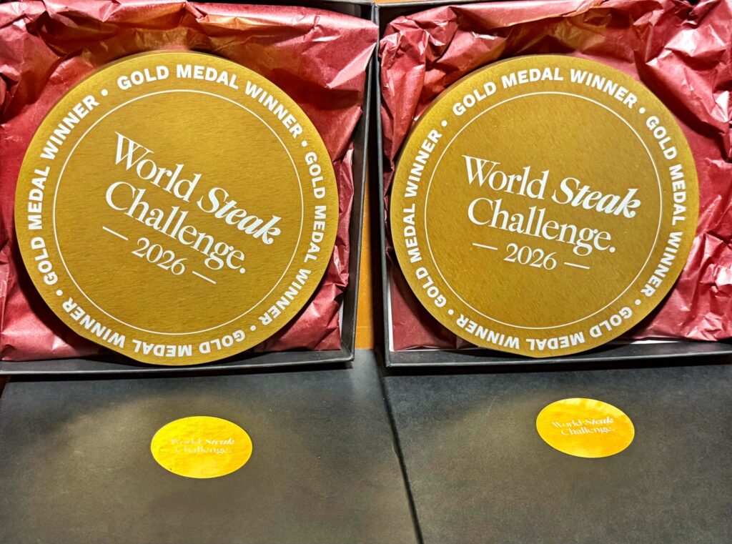 Two World Steak Challenge 2026 Gold Medal Winner seals packaged in gift boxes with red tissue paper